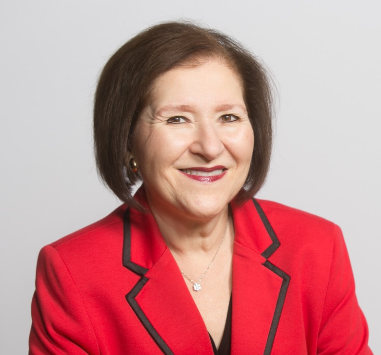 Headshot of a woman in a red blazer